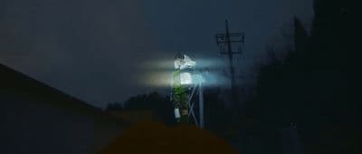 a person standing on top of a roof under a street light