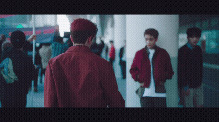 a group of people walking down a hallway