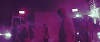 a group of people standing around in a room