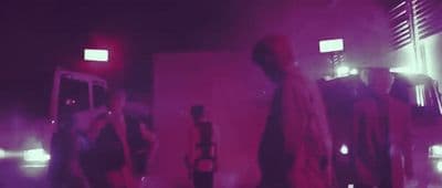 a group of people standing around in a room