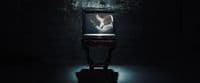 a television sitting in the middle of a dark room
