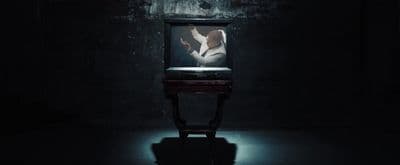 a television sitting in the middle of a dark room