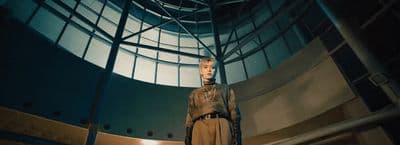 a mannequin is standing in a room with a round window