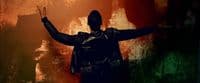 a man standing in front of a wall with his arms outstretched