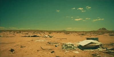 an abandoned building in the middle of a desert