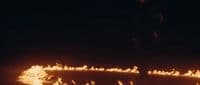 a man standing in front of a lot of fire