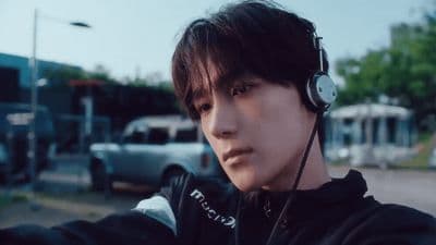 a man wearing headphones and a black jacket