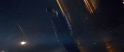 a man walking down a street at night