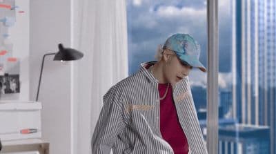 a person in a room with a view of the city
