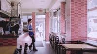 a woman standing at a counter in a restaurant