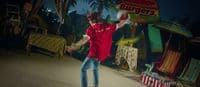 a man in a red shirt throwing a frisbee