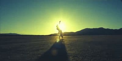 a person standing in the middle of a desert