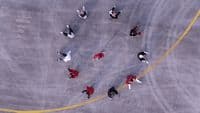 a group of people walking across a parking lot