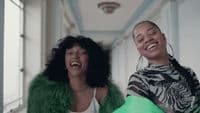 a man and a woman laughing in a hallway