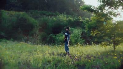 a man standing in a field of tall grass