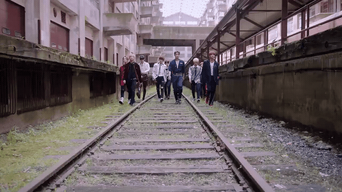 a group of people walking down a train track