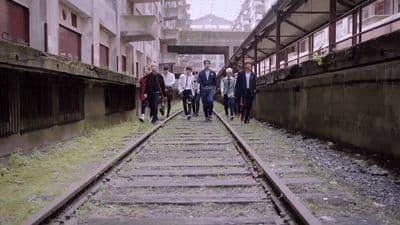 a group of people walking down a train track