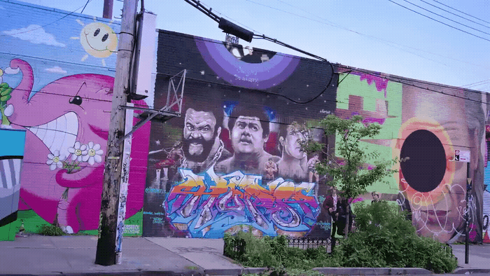 a wall with a bunch of graffiti on it