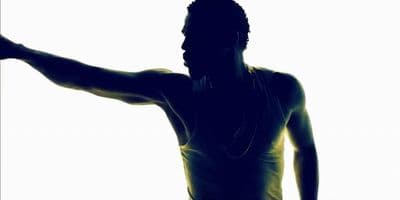 a silhouette of a man holding a tennis racquet