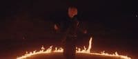 a man standing in a circle of fire