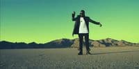 a man standing in the middle of a desert