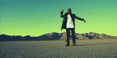 a man standing in the middle of a desert