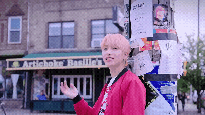 a woman standing next to a pole with a bunch of papers on it