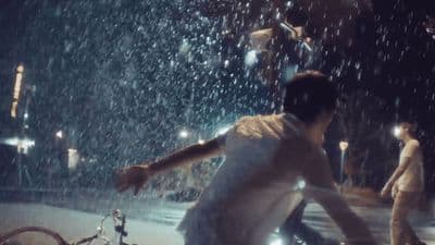 a man is running through the rain with his bicycle