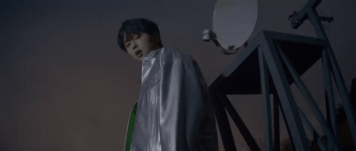 a man standing in front of a satellite dish