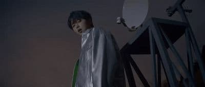 a man standing in front of a satellite dish