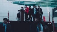 a group of young men standing on top of a stage