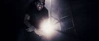 a man holding a flashlight in a dark room