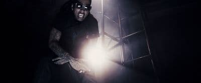 a man holding a flashlight in a dark room