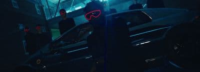 a person standing next to a car in the dark