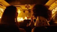 a couple of women sitting in the back of a car