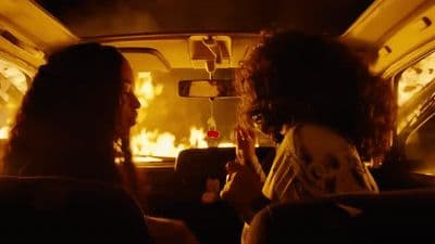 a couple of women sitting in the back of a car