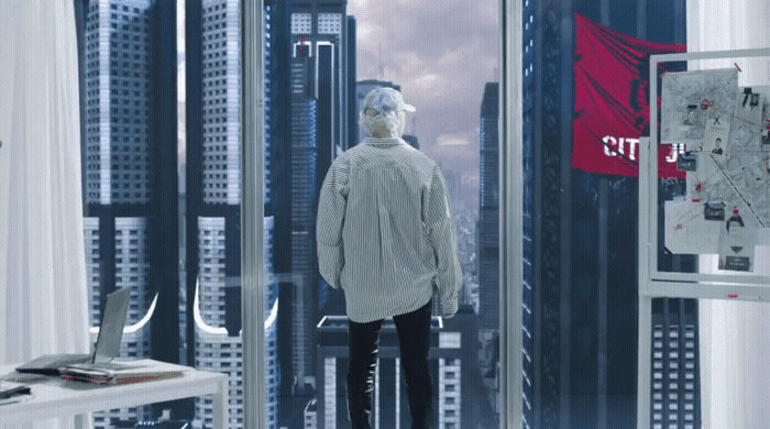 a man standing in a room with a city view