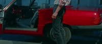 a man standing in front of a red truck