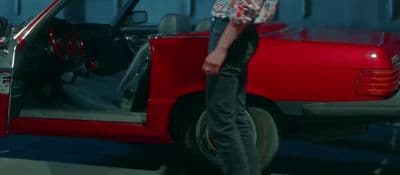 a man standing in front of a red truck