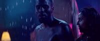 a man and a woman standing in the rain