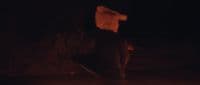 a blurry image of a person holding a skateboard