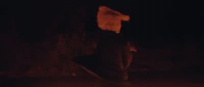 a blurry image of a person holding a skateboard