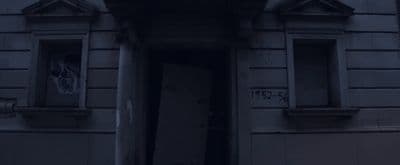 an open door to a building with graffiti on it