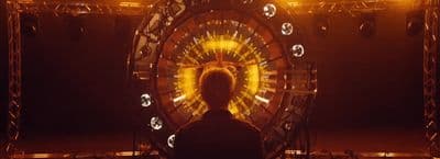a man standing in front of a ferris wheel