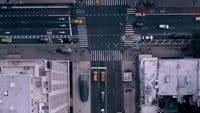 an aerial view of a city street with cars and buses