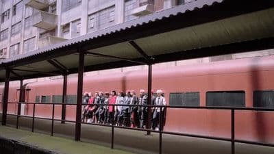 a group of people standing on a platform next to a train