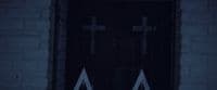a door with two crosses on it in the dark