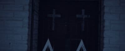 a door with two crosses on it in the dark