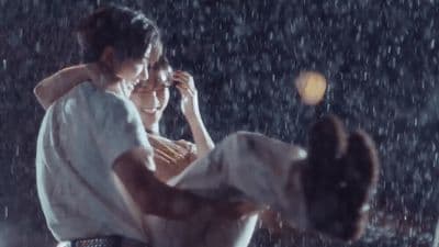 a man holding a woman in the rain