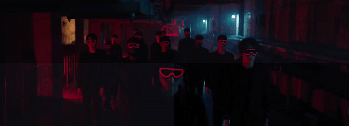 a group of people wearing masks in a dark hallway